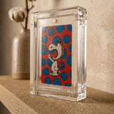 Phantom Display Prism acrylic one-touch case holding ungraded Snoopy trading card on neutral background