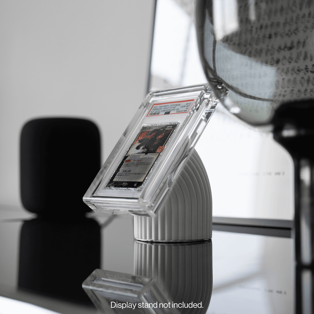 A graded card in a Phantom Magneto display held on a magnetic desk stand