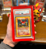 Phantom Display acrylic case with red frame holding a PSA-graded 2001 Neo Revelation Ho-Oh card, offering 99.6% UV protection for valuable collectible cards.