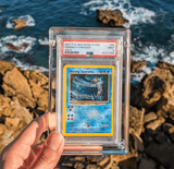 Phantom Display crystal acrylic case holding a PSA-graded Shining Gyarados card, offering 99.6% UV protection for collectible cards.