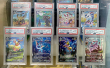 Display of graded Pokémon cards featuring VMAX Eeveelution cards, protected in high-grade acrylic cases. Cards include Flareon, Umbreon, Sylveon, and Espeon with pristine PSA 10 ratings, showcased upright in premium Phantom Display stands.