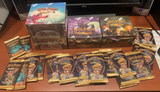 Sealed booster boxes and packs from the Harry Potter Trading Card Game, including Chamber of Secrets and Diagon Alley expansions, displayed on a table.