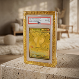 Phantom Display Magneto Color case in textured gold with Rounded smooth edges, holding PSA GEM MT 10 Mega Charizard X ex, free-standing on stone surface #color_textured-gold