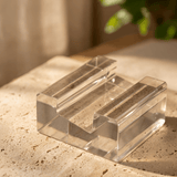 Clear acrylic display stand for graded cards, angled view