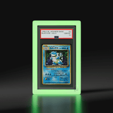 A Phantom Display glow-in-the-dark slab case featuring a Japanese Basic Holo Blastoise card, graded GEM MT 10 by PSA, beautifully illuminated with a ghostly aura. #authenticator_psa/cgc