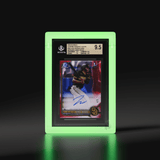 A Phantom Display glow-in-the-dark slab case holding a 2022 Bowman Chrome Prospect Autos James Wood Red Lava Refractor card, graded 9.5 by Beckett, emitting a ghostly glow. #authenticator_bgs