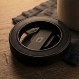 Close-up of Magneto magnetic wall mount base in matte black with Phantom Display logo, showing textured grip ring.