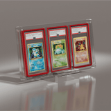 Angled view of PSA graded Pokémon cards (Blastoise, Venusaur, Charizard) in a triple Phantom Display case with GradedGuard red frames. #authenticator_psa/cgc