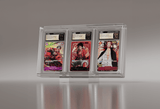 Close-up of triple CGC graded One Piece cards, showcasing Luffy, Zoro, and Shanks, in a sleek, clear acrylic display case designed for high-end collectible cards.