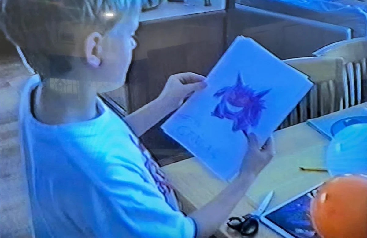 A young collector with a Pokemon drawing, a childhood memory